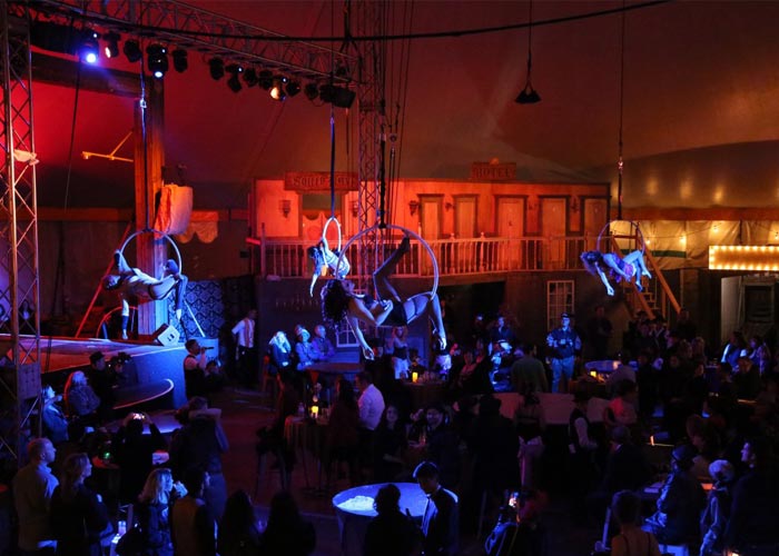Image of The Soiled Dove aerialists performing under the Tortona Big Top in Downtown Oakland
